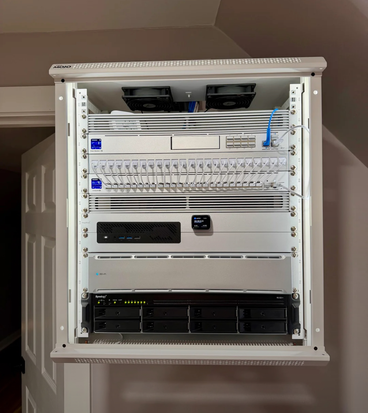 Network rack with camera and green led lighting on wall