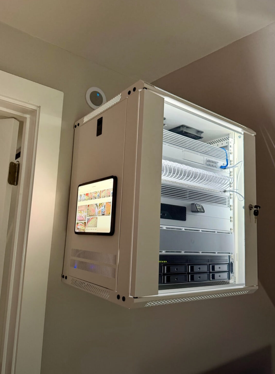 High end security camera cabinet with tablet affixed and lighting with networking gear