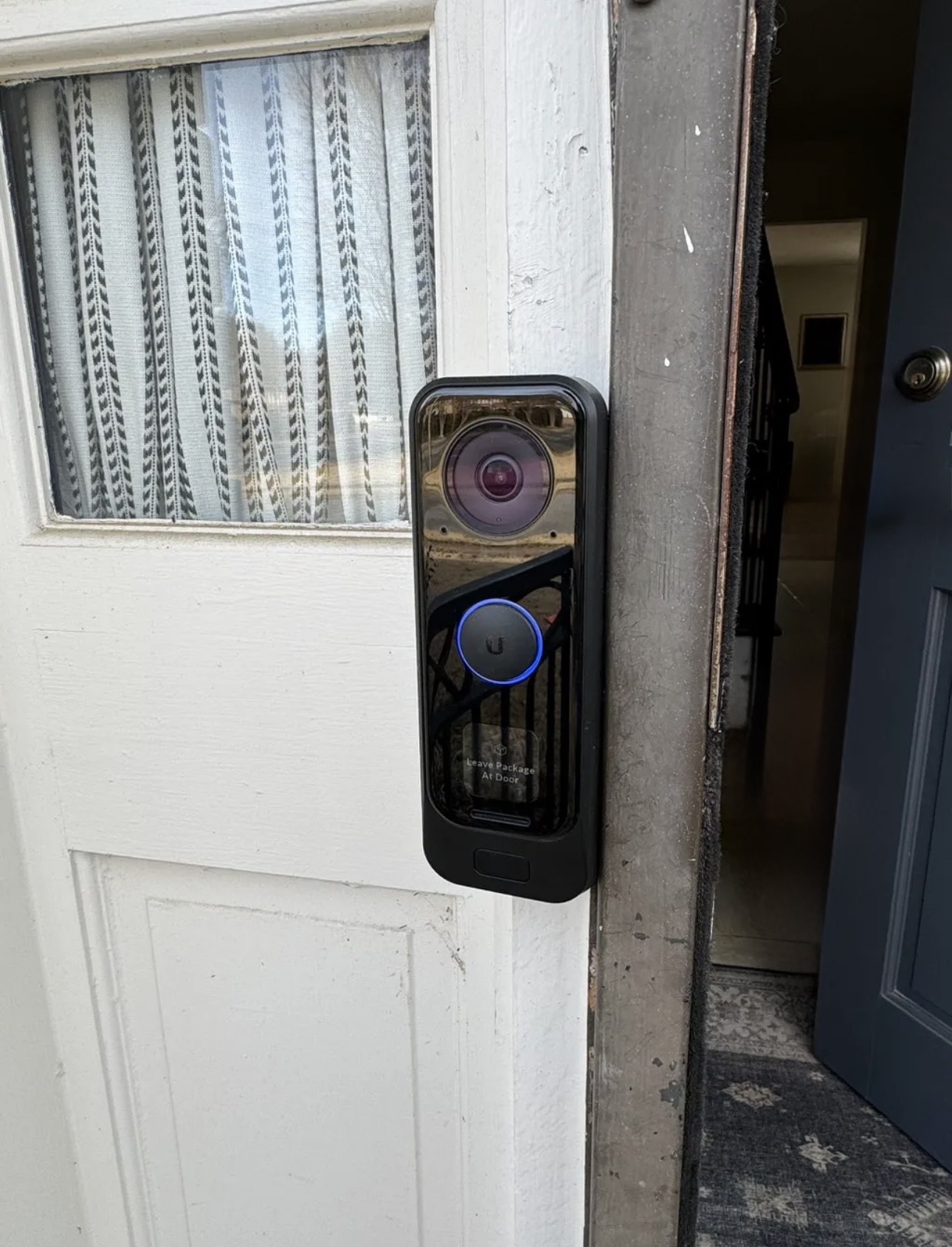 black plastic ubiquiti video doorbell on the front of a home recording for safety
